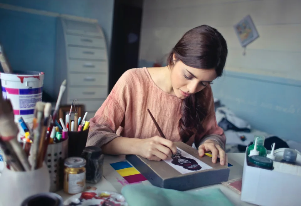 Designer developing artwork and color ideas at a studio desk.