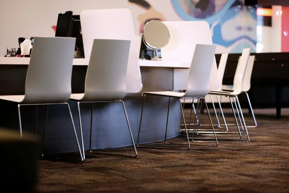 Chairs, mirrors, and workstations in a beauty salon.
