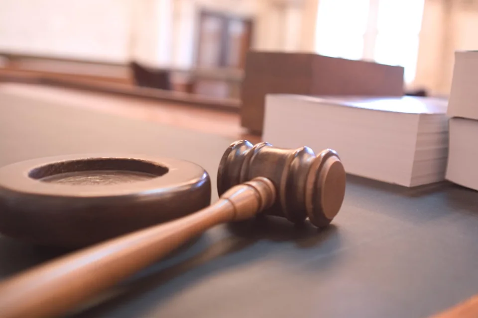 A wooden gavel and sound block in a courtroom.