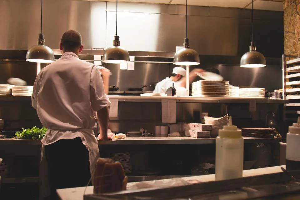 Chefs working together in a restaurant kitchen.