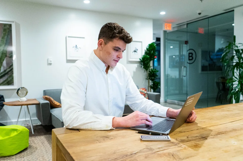 Professional working on a laptop in a shared office.