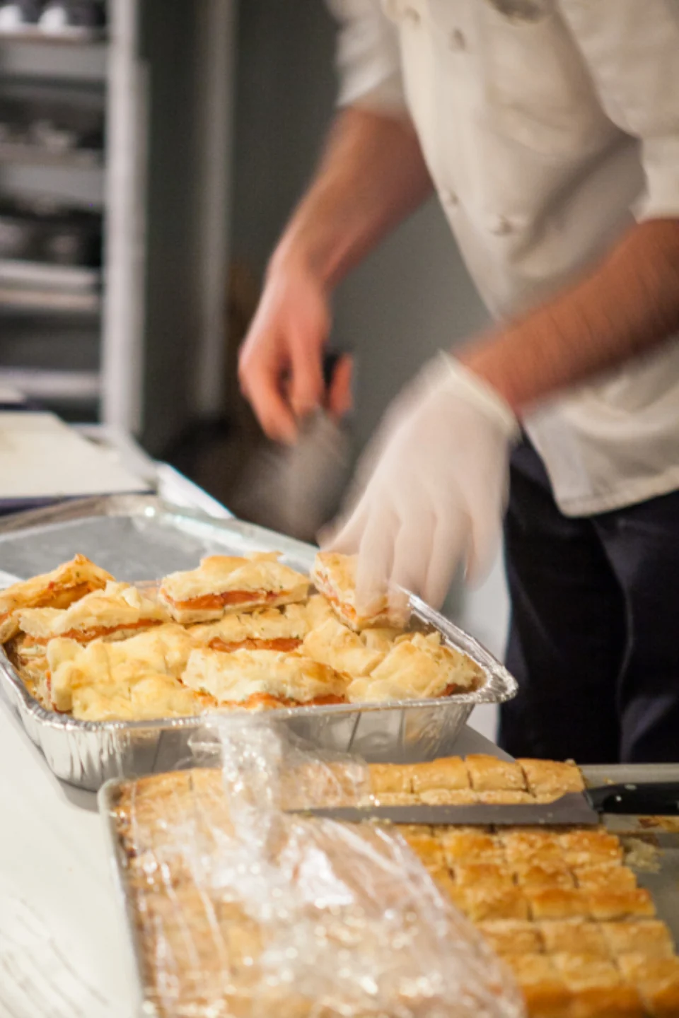 Chef preparing pastry in a professional kitchen.
