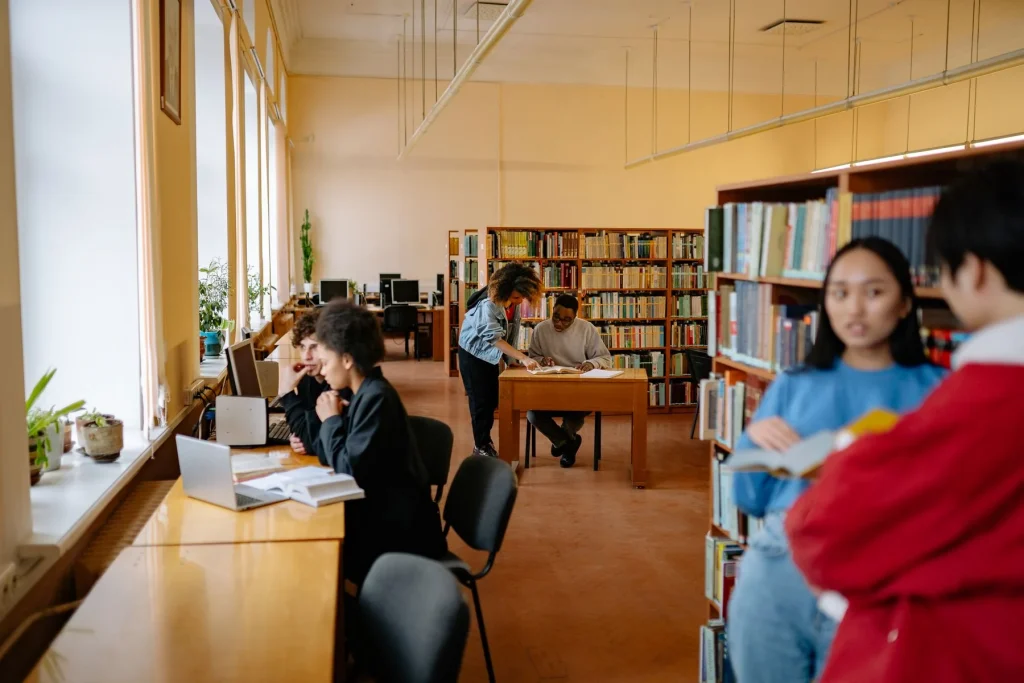 Students sharing notes and studying together in a library