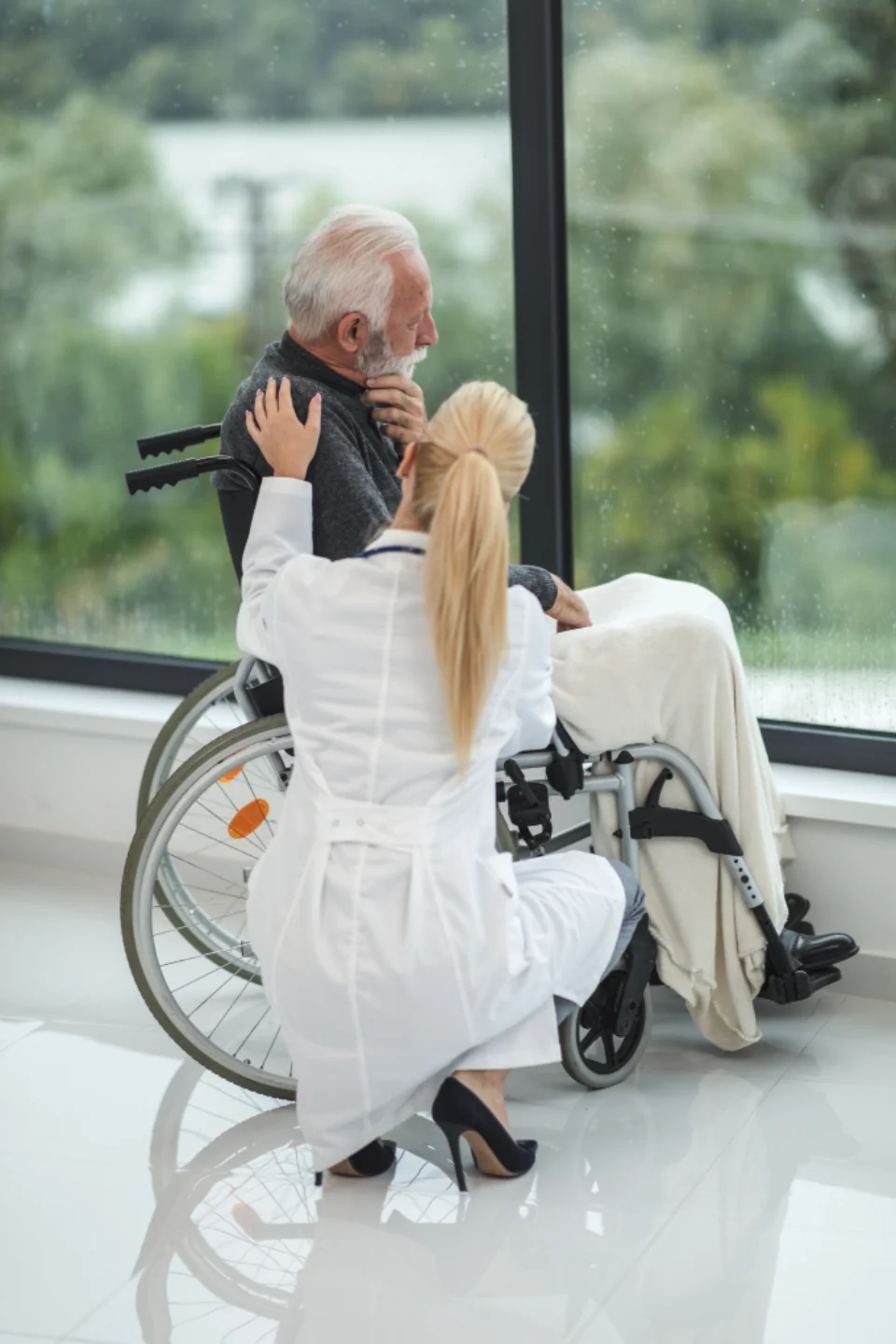 Person in a wheelchair using a camera with another person nearby.