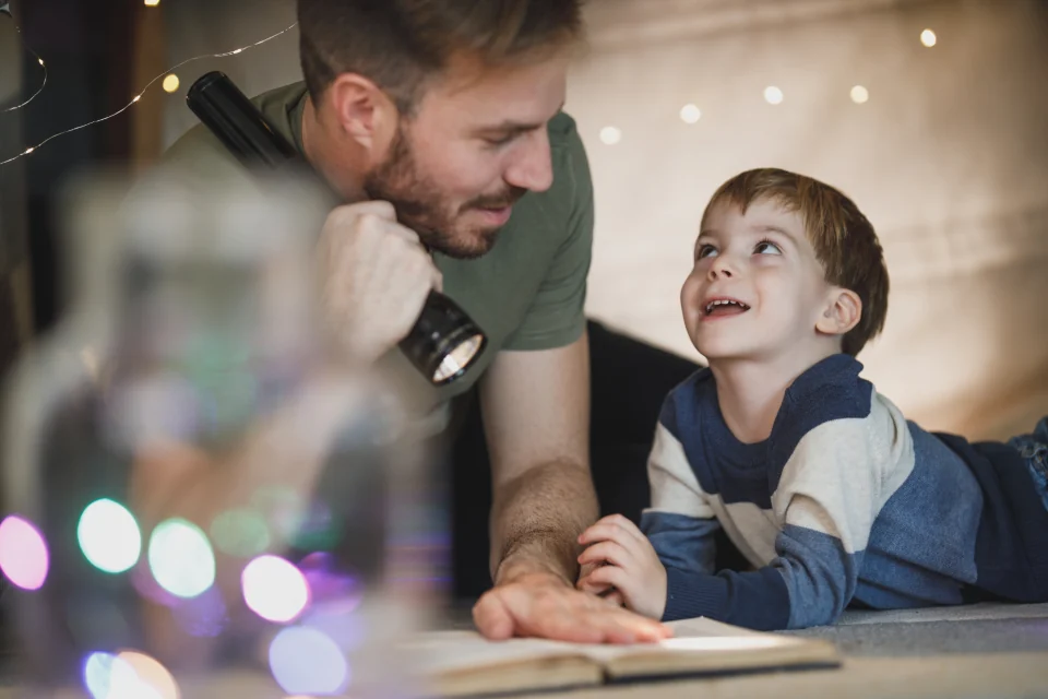 Adult and child reading together.